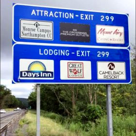 blue attraction sign along a highway