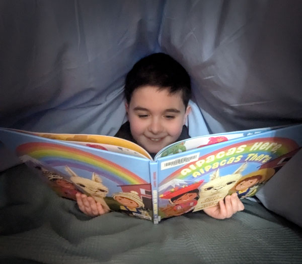 reading the book Alpacas Here, Alpacas There